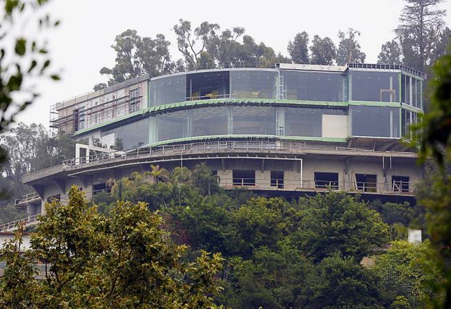 This May 31, 2017 file photo shows a huge mansion under construction on Strada Vecchia Road in the Bel Air district of Los Angeles. Mohamed Hadid, the father of fashion models Bella and Gigi Hadid, has been fined and given community service for illegally building the gigantic mansion in Los Angeles' Bel Air district. 