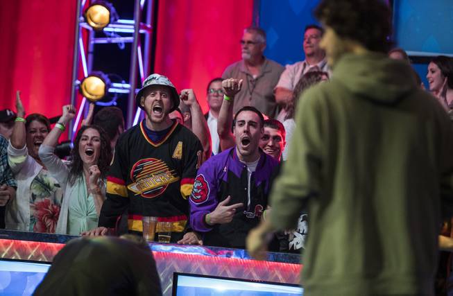 Fans cheer for Daniel Ott after a big pot win during the second of three straight nights to finish poker's world championship as the table goes from 7 to 3 players at the Rio on Friday, July 21 2017.