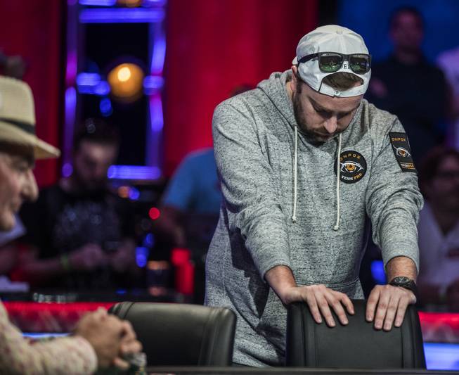 Antoine Saout can't even look at the cards after going all in during the second of three straight nights to finish poker's world championship as the table goes from 7 to 3 players at the Rio on Friday, July 21 2017.