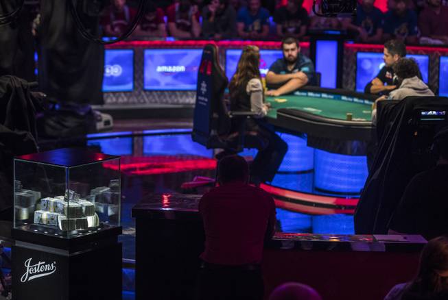 Stacks on money and a jeweled bracelet await the winner during the last night of the WSOP to finish poker's world championship as the table goes from 3 to a winner at the Rio on Saturday, July 22 2017.