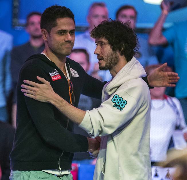 Benjamin Pollak is consoled by Dan Ott after being knocking out and finishing in third place during the last night of the WSOP to finish poker's world championship at the Rio on Saturday, July 22 2017.