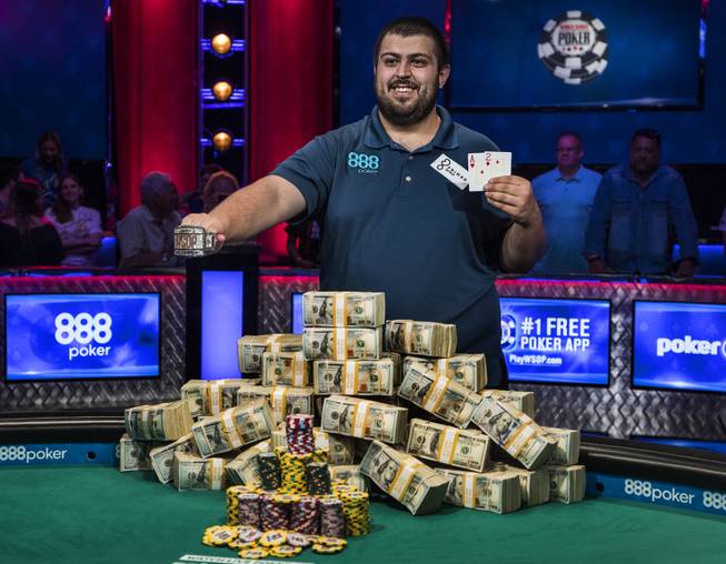 Scott Blumstein shows off his WSOP bracelet, winning cards and a pile of cash after a first place finish in poker's world championship at the Rio on Sunday, July 23 2017.
