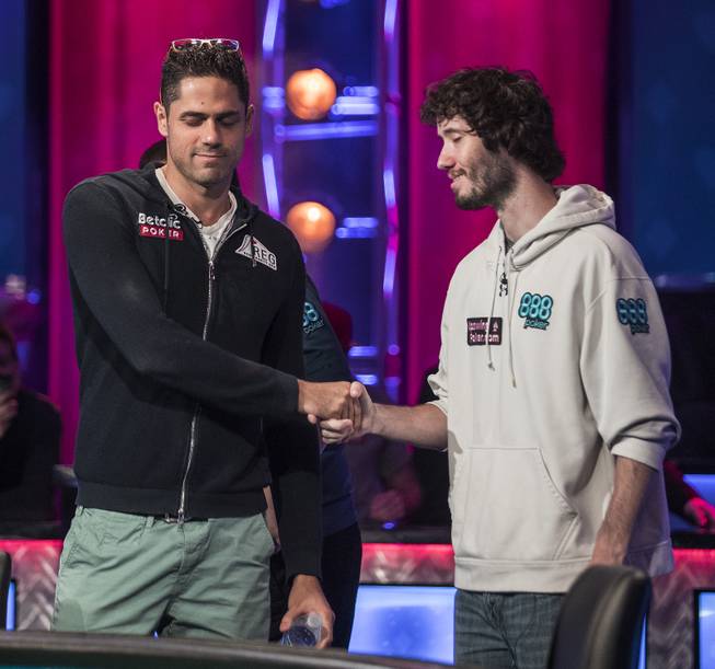 Benjamin Pollak and Dan Ott shake hands during the last night of the WSOP to finish poker's world championship as the table goes from 3 to a winner at the Rio on Saturday, July 22 2017.