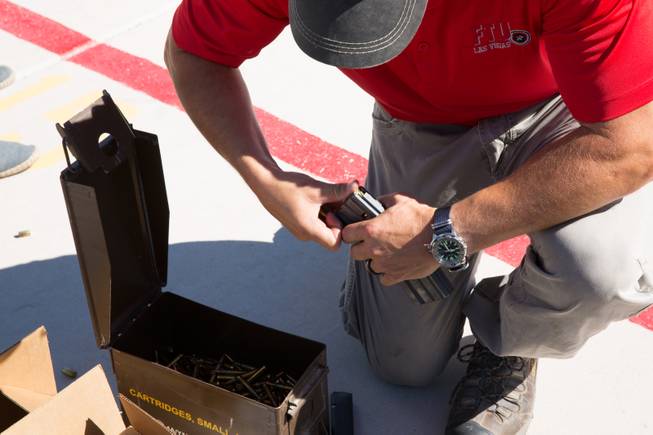 FBI Firearms Instructor Chris McInnes loads 5.56mm ammunition into a 30-round magazine during a firearms demonstration at the FBI shooting complex, Friday June 16, 2017.