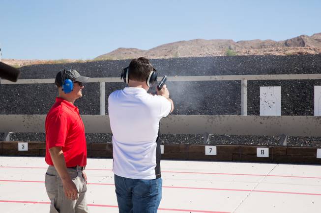 FBI Firearms Instructor Chris McInnes watches over a shooter during a firearms demonstration at the FBI shooting complex, Friday June 16, 2017.