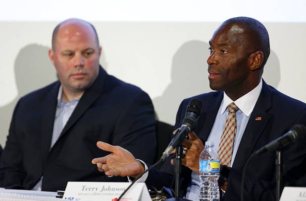 Terry Johnson, right, a member of the Nevada Gaming Control Board, speaks during a Responsible Gaming Panel at UNLV Thursday, Aug. 3, 2017.  Tim Richards, senior vice president payments innovation for Everi, listens at left.