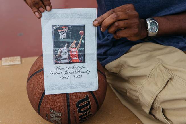 Reggie Williams holds a letter from Patrick James Denny's memorial service.