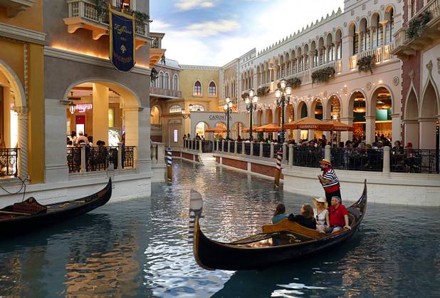Tourists take a gondola ride at the Canal Shoppes in the Venetian on the Las Vegas Strip Tuesday, Aug. 8, 2017.