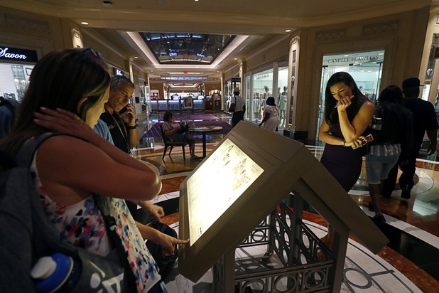 Shoppers check a directory at the Shoppes at the Palazzo on the Las Vegas Strip Tuesday, Aug. 8, 2017.