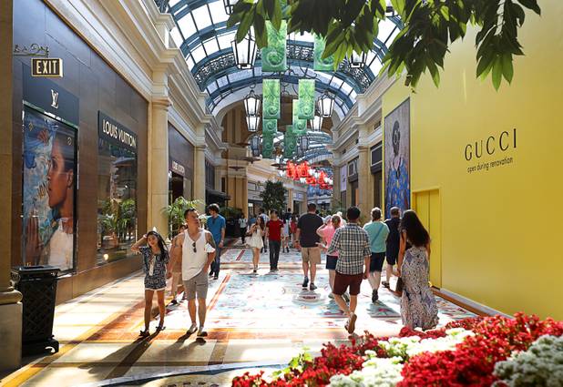 People walk through a retail and dining area of the Bellagio on the Las Vegas Strip Tuesday, Aug. 8, 2017.