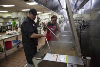Executive Chef Jeremy Woods prepares for the lunch-time meal, one of 4 meals the Salvation Army prepares for the public at their downtown Las Vegas Dining Facility, Monday, July 31, 2017.