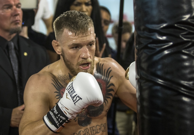 Conor McGregor hits a bag during a media workout before ...