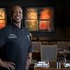 Chef Henry Jones poses in a dining area of the Redwood Steakhouse in the California Hotel Monday, Aug. 14, 2017.
