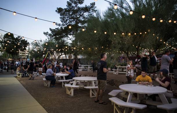 Attendees wander about under the lights and enjoy during the Motley Brews Hopped Taco Throwdown about The Backyard at Zappos on Saturday, August 12, 2017.