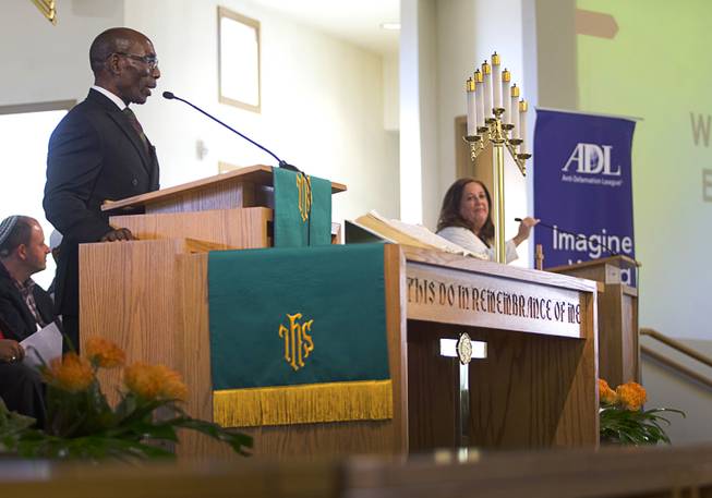 Ralph Williamson, left, senior pastor of First African Methodist Episcopal Church, and Jolie Brislin, regional director of the Anti-Defamation League, speak during an interfaith Peace and Unity Vigil at the church in North Las Vegas Sunday, Aug. 20, 2017. The Anti-Defamation League and First AME Church sponsored the event.