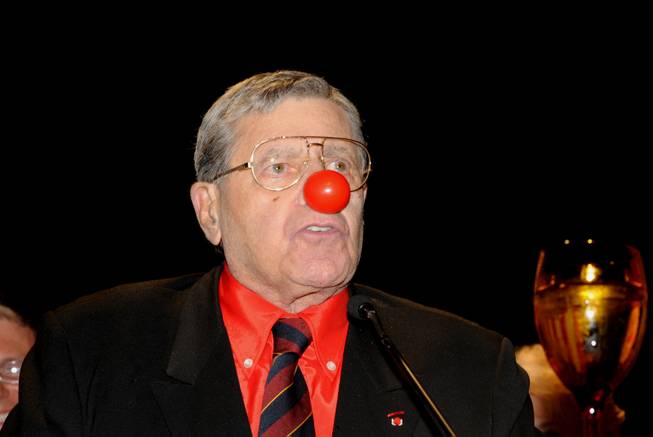 In this photo provided by the Las Vegas News Bureau, Jerry Lewis accepts the Nevada Broadcasters Association (NBA) Lifetime Achievement Award, in true Jerry Lewis style wearing his red clown nose, at Red Rock Station in Las Vegas. Also on hand to honor Jerry Lewis were Nevada Governor Brian Sandoval, Congresswoman Shelley Berkley, Congressman Joe Heck and former Las Vegas Mayor Oscar B. Goodman. Saturday, August 20, 2011. 