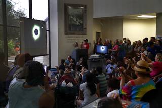 People watch a live feed of the solar eclipse during a viewing event at the College of Southern Nevada Cheyenne campus Monday, Aug. 21, 2017. Rainy weather obscured the viewing in Las Vegas.
