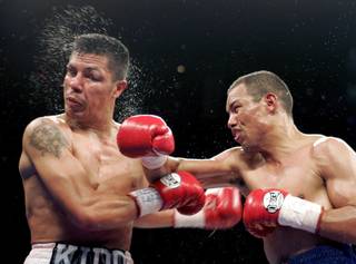 WBC lightweight champion Jose Luis Castillo of Mexico connects on Julio Diaz during their title fight at the Mandalay Bay Events Center in Las Vegas, Nevada March 5, 2005. Castillo retained his title with a 10th round TKO. REUTERS/Steve Marcus