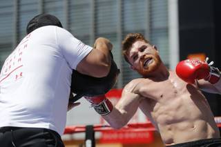 Boxer Canelo Alvarez works out as he hosts an open-to-the-public media workout at L.A. LIVE in Los Angeles on Monday, Aug. 28, 2017.