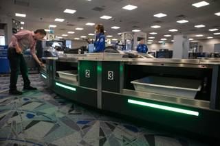 Travelers use new automated screening lanes at the security checkpoint in Terminal 3 at McCarran International Airport in Las Vegas, Nev. on August 31, 2017.