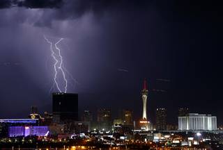 Lightning strikes to the northwest of downtown Las Vegas as a thunderstorm passes through the valley Wednesday, Sept. 13, 2017.