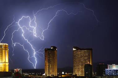 Lightning strikes behind Las Vegas Strip casinos as a thunderstorm passes through the northwest valley Wednesday, Sept. 13, 2017.
