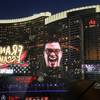 An advertisement for Mexican entertainer Franco Escamilla is reflected in a window along the Las Vegas Strip, Thursday, Sept. 14, 2017. Often mistaken for Cinco de Mayo, Mexican Independence Day will be celebrated this weekend, and as an entertainment oasis near Mexico, Las Vegas will roll out the red, white and green carpet to celebrate "El Grito."