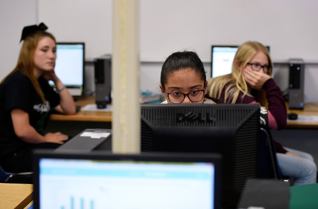 Ninth grader Jasmine Wright, center, uses a computer during her algebra class at Beatty High School on Friday, Sept. 15, 2017, in Beatty. Gov. Brian Sandoval and Valley Communications Association celebrated the connection of the company's high-speed fiber to the Beatty, Nev. school and the beginning of construction for the first all-fiber community in Nevada.