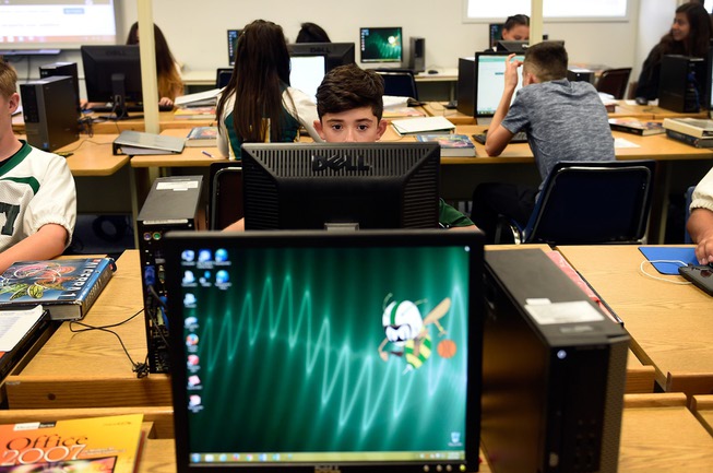Ninth grader Ethan Mendoza, center, uses a computer during his algebra class at Beatty High School on Friday, Sept. 15, 2017, in Beatty. Gov. Brian Sandoval and Valley Communications Association celebrated the connection of the company's high-speed fiber to the Beatty, Nev. school and the beginning of construction for the first all-fiber community in Nevada.