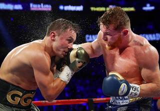 WBC/WBA/IBF middleweight champion Grennady Golovkin, left, of Kazakhstan takes a punch from Canelo Alvarez of Mexico during their title fight at T-Mobile Saturday Saturday, Sept. 16, 2017. The boxers fought to a draw and Golovkin retained his titles.