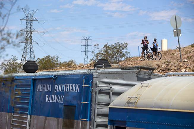 Cyclists take a photo of a Nevada Southern Railway train  behind the Railroad Pass hotel-casino Sunday, Sept. 17, 2017.