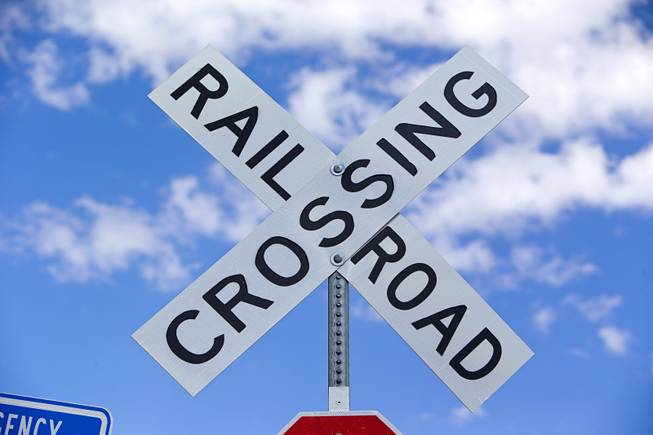 A train crossing sign is shown by railroad tracks behind the Railroad Pass hotel-casino Sunday, Sept. 17, 2017.