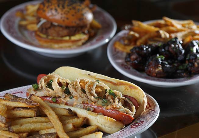 Seat Thai Dog, foreground, West Indies Fried Chicken Sandwich, back, and Fish Sauce Chicken Wings at Starboard Tack, 2601 Atlantic St., Tuesday, Sept. 19, 2017.