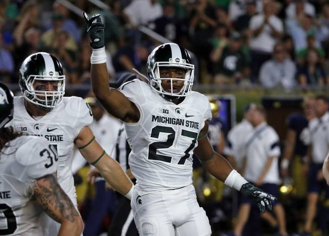Michigan State safety Khari Willis (27) celebrates a fumble recovery on a punt during the first half of an NCAA college football game against Notre Dame, Saturday, Sept. 17, 2016, in South Bend, Ind.