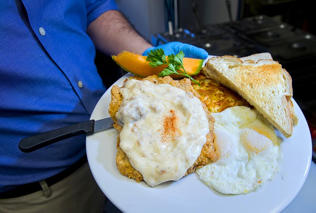 A Chicken Fried Steak and Eggs breakfast is displayed at ...