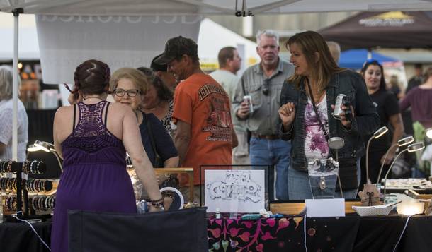 Attendees check out the jewelry for sale in the Get Stoned booth during Henderson's Last Friday, Just Add Water Street on Friday, September 22, 2017.