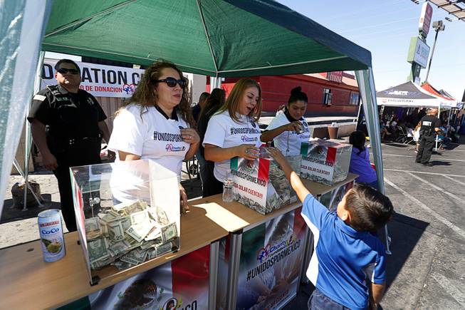 A boy puts a donation into a box during an earthquake relief event in front of Mariana's Supermarket at West Sahara Avenue Sunday, Sept. 24, 2017. Marianas Charity Foundation hosted the event to raise donations for victims of the recent devastating earthquake in Central Mexico. The foundation promised to match donations, dollar for dollar, up to $20,000, said Ruben Anaya, COO of Mariana's Supermarkets.