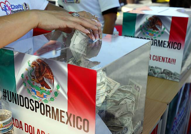 A woman puts a donation into a box during an earthquake relief event in front of Mariana's Supermarket at West Sahara Avenue Sunday, Sept. 24, 2017. Marianas Charity Foundation hosted the event to raise donations for victims of the recent devastating earthquake in Central Mexico. The foundation promised to match donations, dollar for dollar, up to $20,000, said Ruben Anaya, COO of Mariana's Supermarkets.