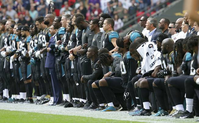 Jags players kneel before anthem