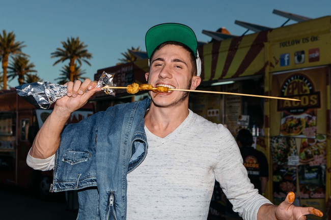 A young man eats shrimp from Nic's Shrimp House during the opening day at the Great American Foodie Fest at Sunset Station in Henderson, Nev. on September 28, 2017.