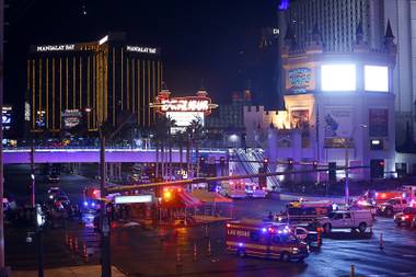 Las Vegas Metro Police and medical workers stage in the intersection of Tropicana Avenue and Las Vegas Boulevard South after a mass shooting at a music festival on the Las Vegas Strip Sunday, Oct. 1, 2017.