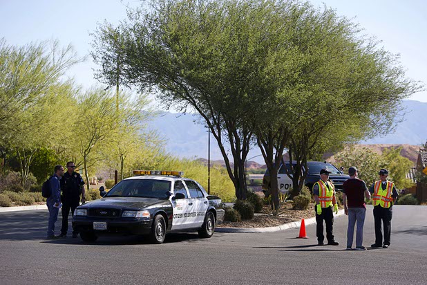 Mesquite Police Sgt. Tracy Fails and members of a citizen volunteer patrol block the entrance to the Prominence community, where mass shooter Stephen Craig Paddock owned a home, in Mesquite, Nev. Monday, Oct. 2, 2017.