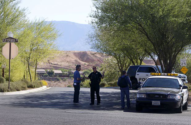 Mesquite Police Sgt. Tracy Fails, center, talks to journalists at the entrance to the Prominence community, where mass shooter Stephen Craig Paddock owned a home, in  Mesquite, Nev. Monday, Oct. 2, 2017.