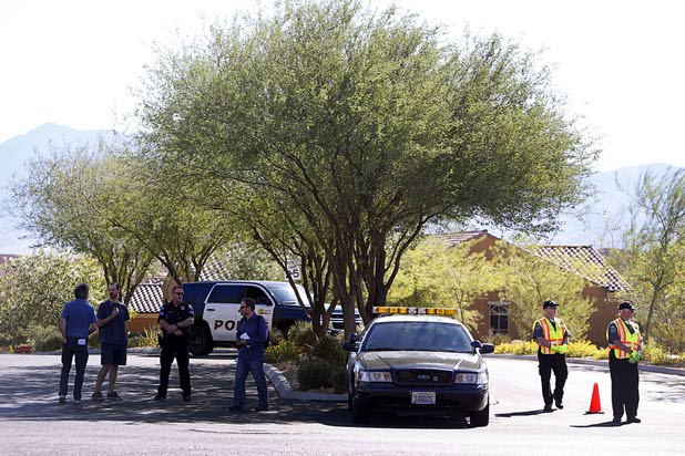 Mesquite Police Sgt. Tracy Fails and members of a citizen volunteer patrol block the entrance to the Prominence community, where mass shooter Stephen Craig Paddock owned a home, in Mesquite, Nev. Monday, Oct. 2, 2017.