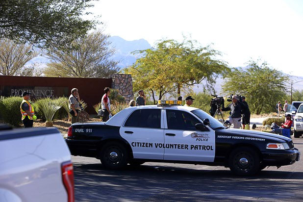 Journalists wait near the entrance to the Prominence community, where mass shooter Stephen Craig Paddock owned a home, in Mesquite, Nev. Monday, Oct. 2, 2017.