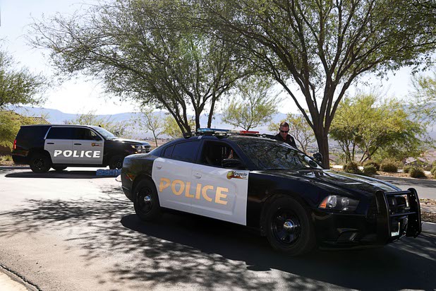 Mesquite Police Sgt. Tracy Fails talks with another officer at the entrance to the Prominence community, where mass shooter Stephen Craig Paddock owned a home, in Mesquite, Nev. Monday, Oct. 2, 2017.