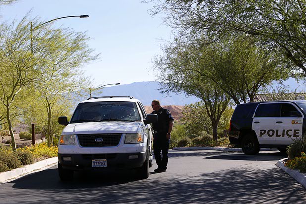 Mesquite Police Sgt. Tracy Fails talks with another officer at the entrance to the Prominence community, where mass shooter Stephen Craig Paddock owned a home, in Mesquite, Nev. Monday, Oct. 2, 2017.