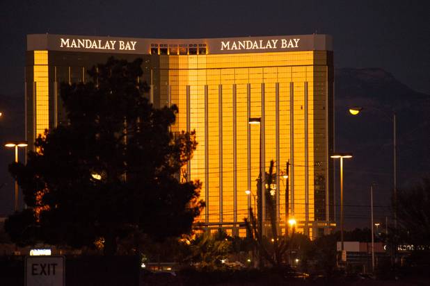 The sun rises on Mandalay Bay Casino as seen from the  Thomas & Mack center where people took refuge, following a mass shooting at the Route 91 music festival along the Las Vegas Strip, Monday, Oct. 2, 2017, in Las Vegas. The gunmen shot at people from the 32nd floor of Mandalay Bay Sunday evening Oct. 1, 2017.