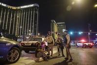 Police officers are shown at the scene of a shooting near Mandalay Bay on the Las Vegas Strip, Sunday, Oct. 1, 2017. Hundreds of victims were transported to hospitals after a shooting late Sunday at a music festival  on the Strip.