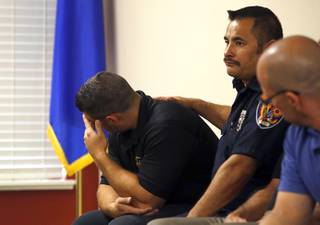 Clark County firefighter Jesse Gomez, center, supports Henderson firefighter Anthony Robone during a news conference at the International Association of Firefighters Union Hall, Local 1285, Tuesday, Oct. 3, 2017. Robone's older brother Nick, an assistant hockey coach at UNLV, was hit by gunfire at the Route 91 Harvest festival on Sunday when gunman Stephen Paddock opened fire on the crowd.